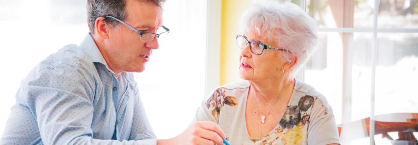Man pointing at a tablet with his mother