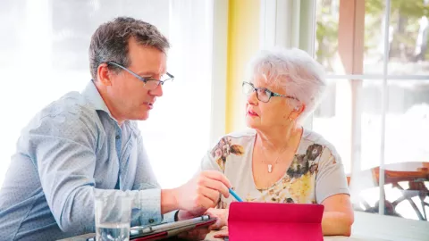 Man pointing at a tablet with his mother